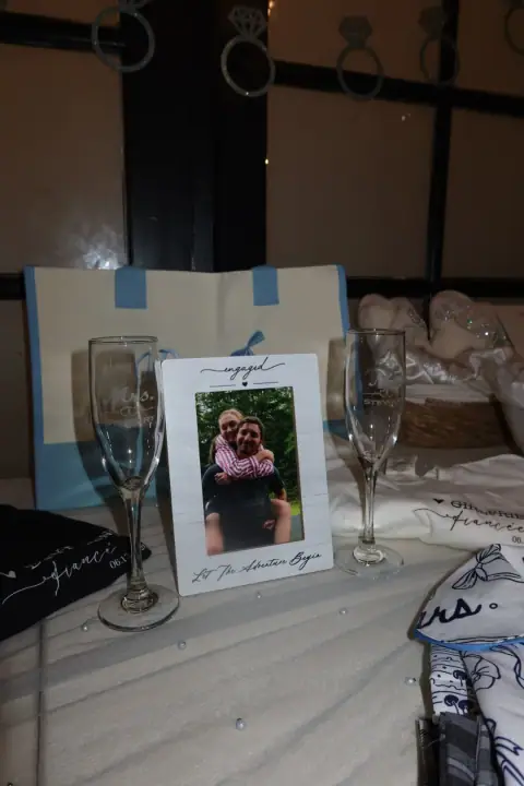 Personalized champagne flutes and a framed photo of Christopher and Jacqueline