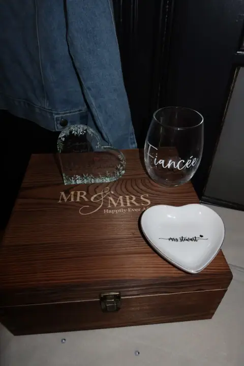 Engagement keepsakes arranged on a wooden memory box
