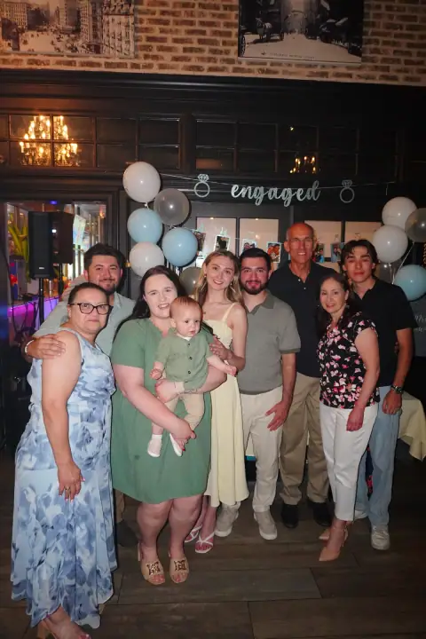 Christopher and Jacqueline surrounded by family at the party
