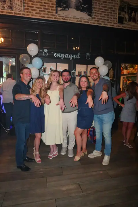 Christopher, Jacqueline, and friends holding out their rings