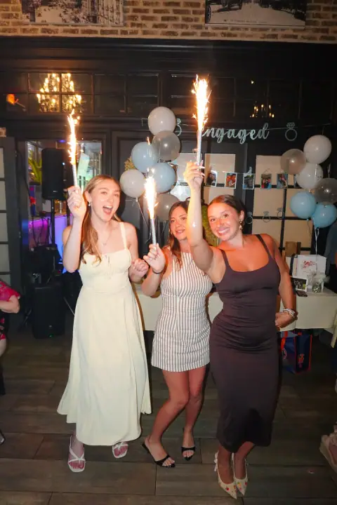 Jacqueline and friends celebrating with sparklers