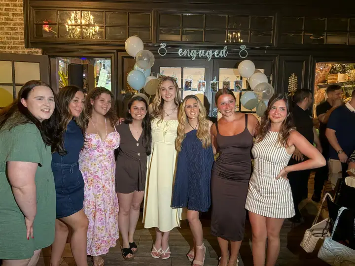 A large group of friends celebrating with Jacqueline