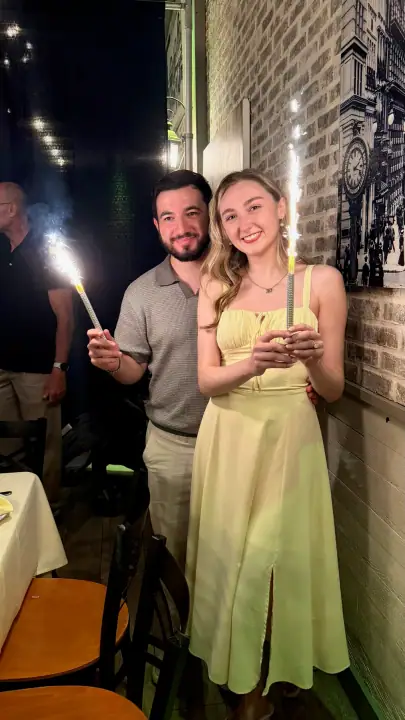 Christopher and Jacqueline smiling together with sparklers