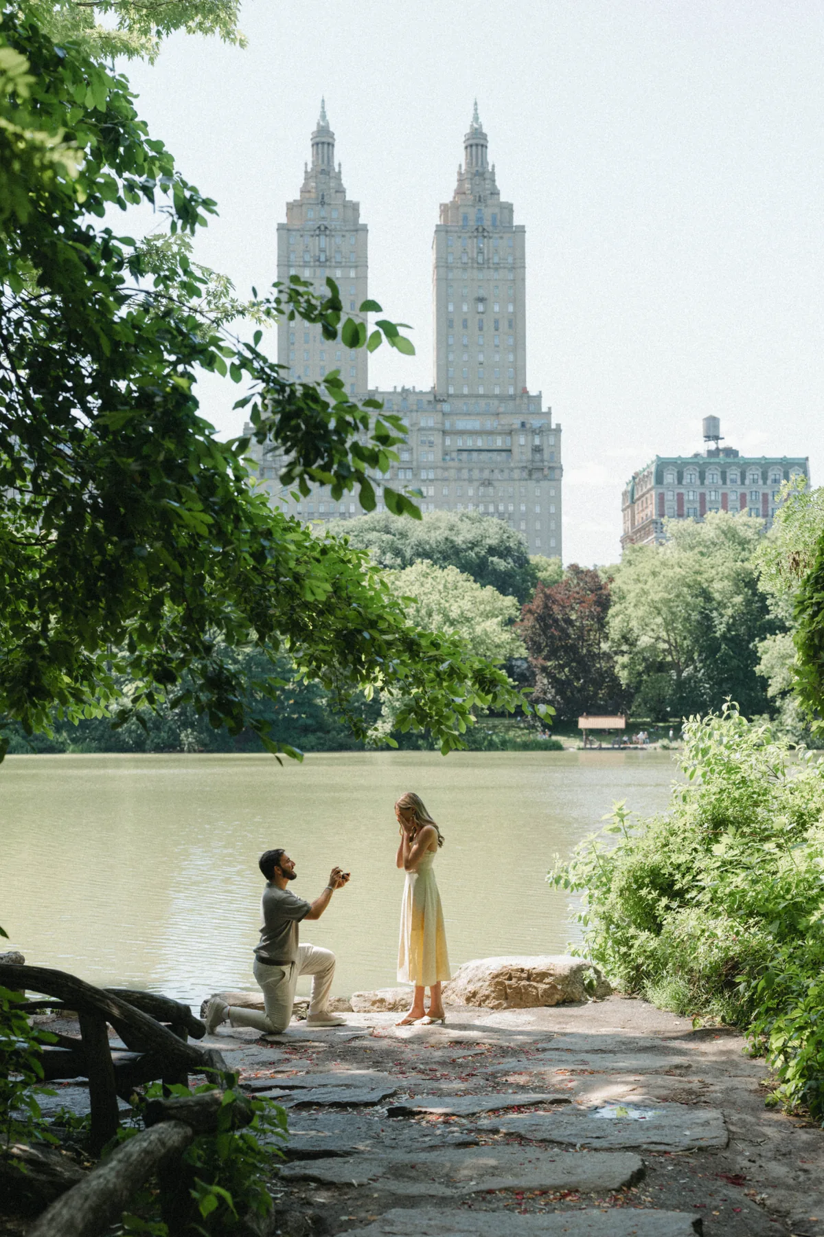 Christopher proposing to Jacqueline by the lake in Central Park