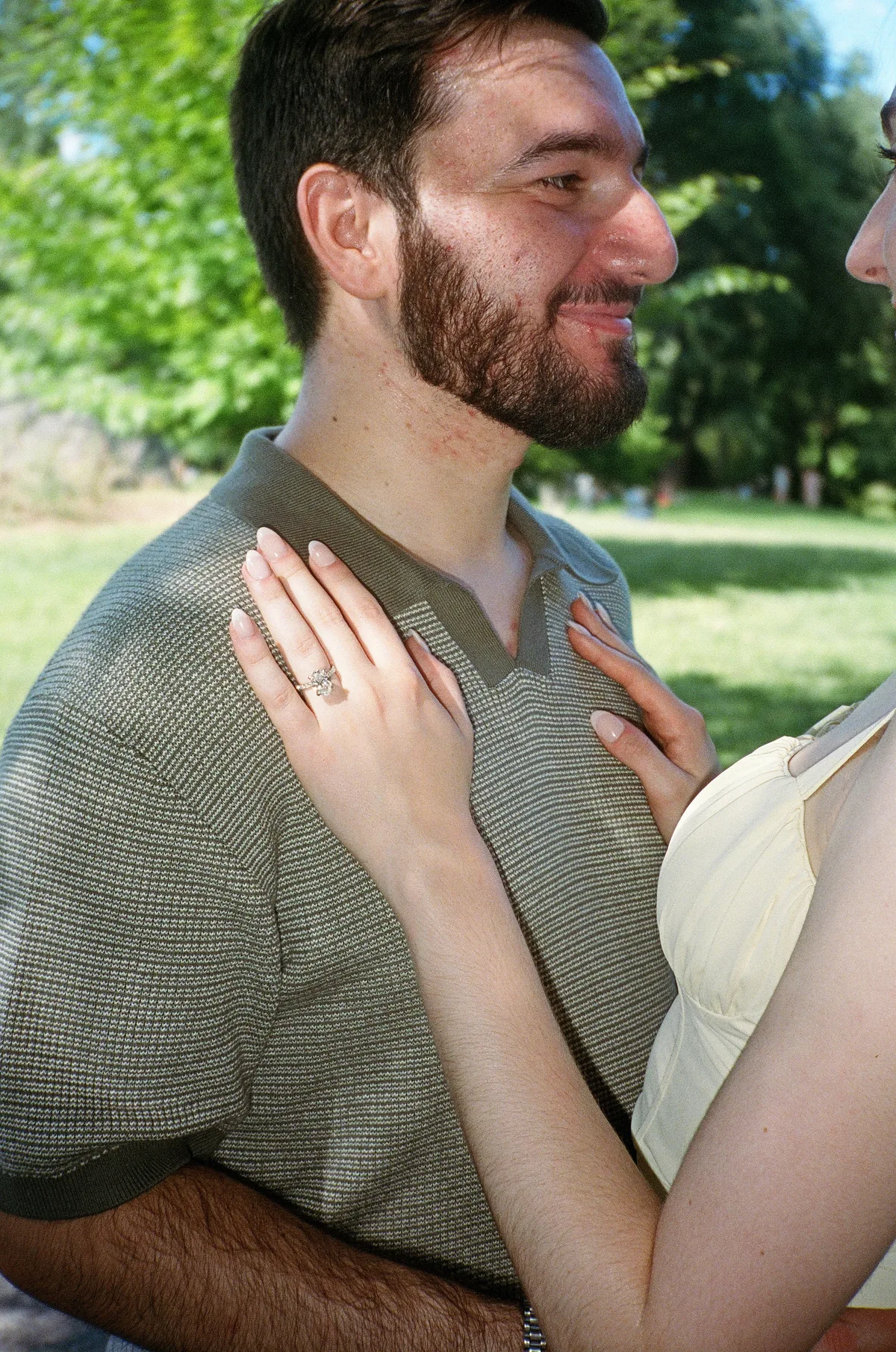 Jacqueline's engagement ring as the couple embraces