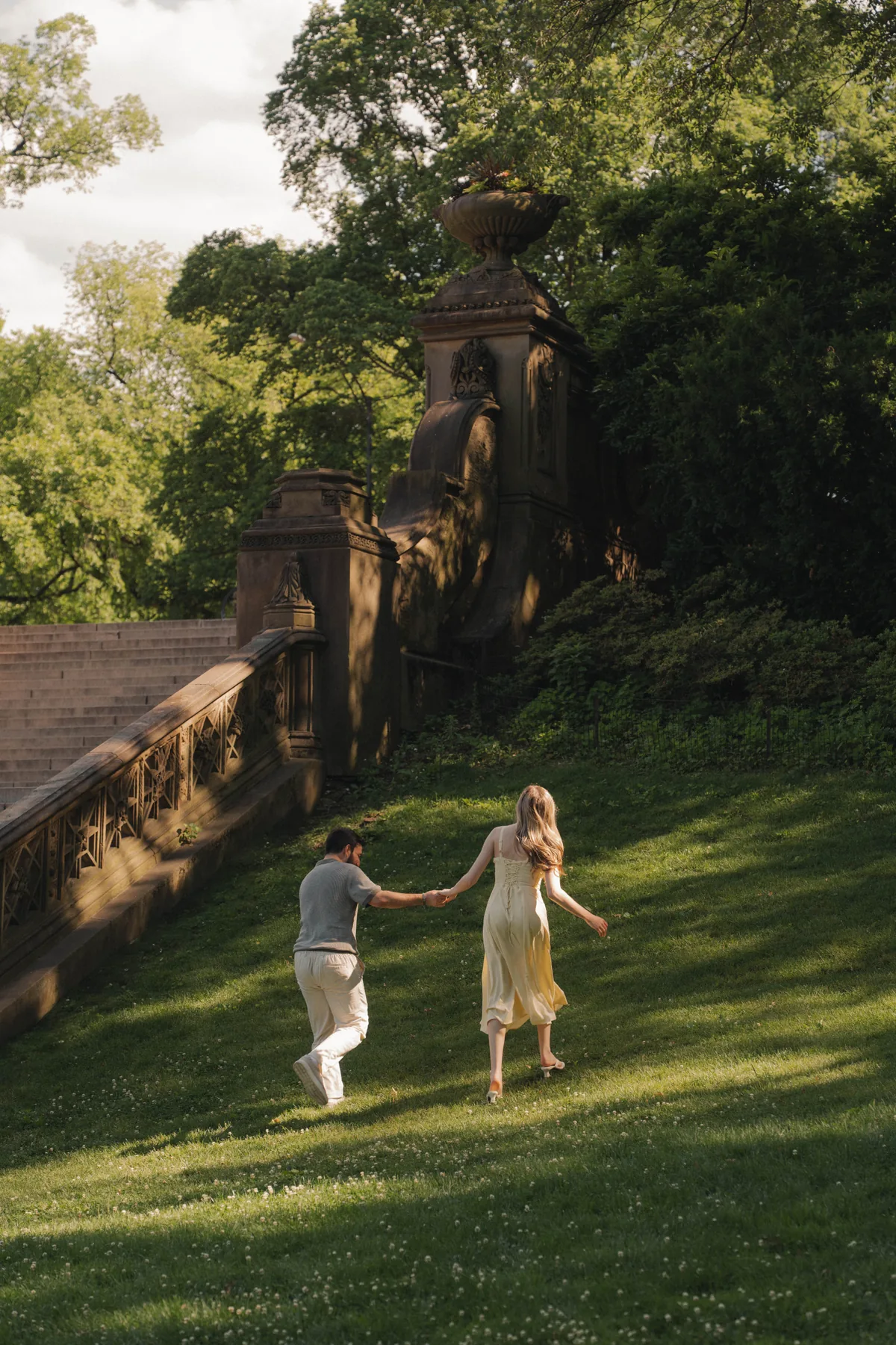 Christopher and Jacqueline running hand in hand through Central Park